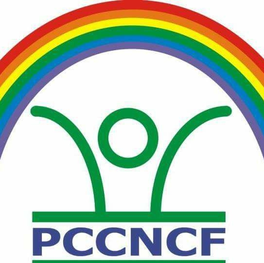 logo shows a rainbow with a stick figure underneath with its arms spread wide. The letters "PCCNCF" are underneath the stick figure.